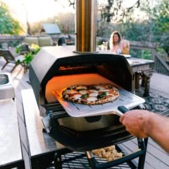 Ooni Karu 16 Inch Portable Wood And Charcoal Fired Outdoor Pizza Oven -Joes BBQs Store Ooni Karu 16 in use c 1024x1024 2x a6dd626e f169 4b2c a6fb dc5befa5ee75